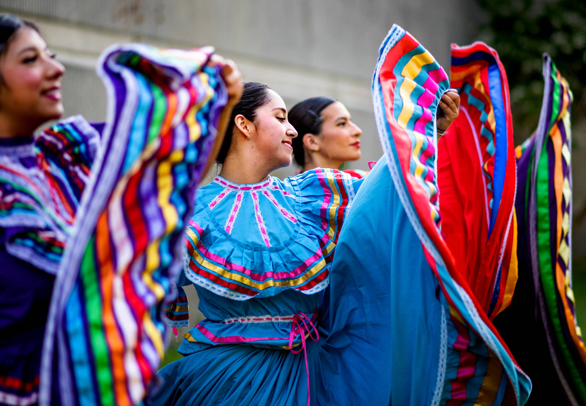 From left, Stephanie Zamudio, Denisse Medina and Giselle Torres dance with Monarcas, a GVSU student organization that performs traditional folkloric dances to showcase and appreciate Mexican culture.